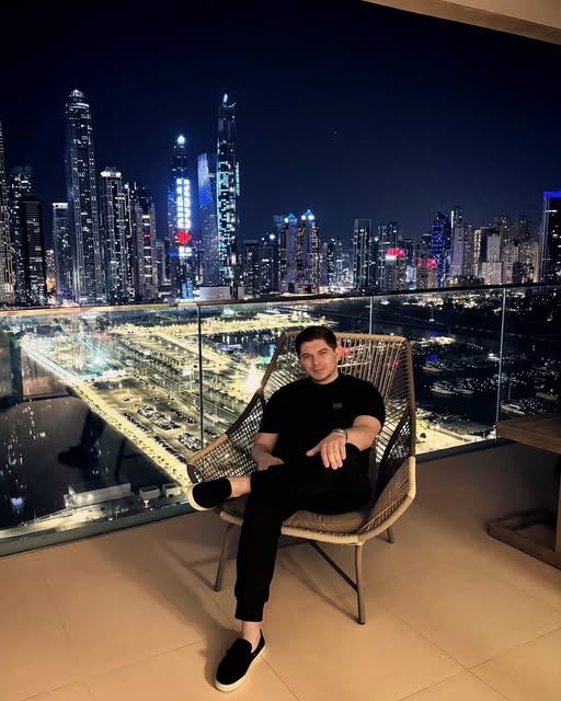 Rustam Kakharov, Founder and CEO of REFINED Properties, seated against the Dubai skyline