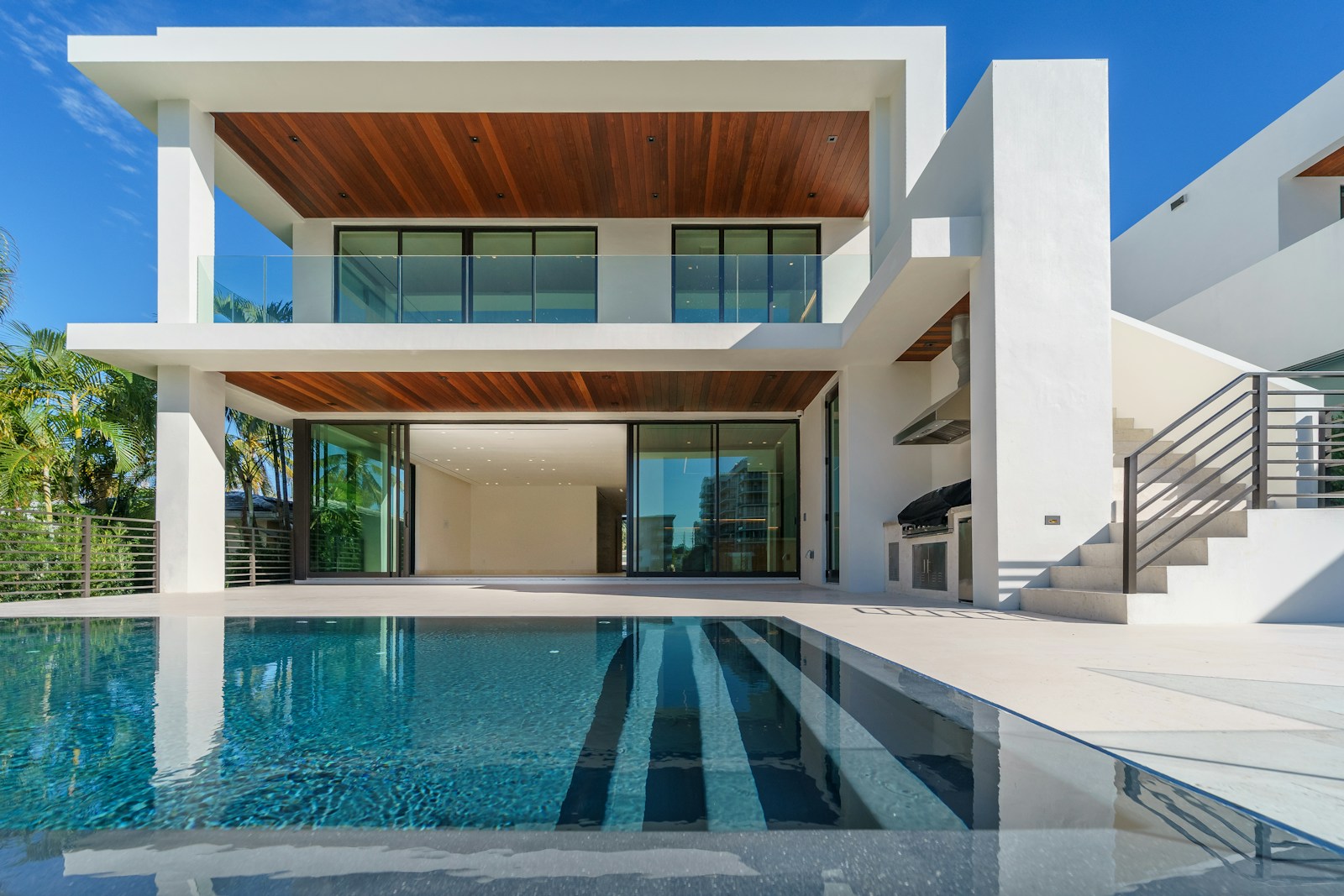 Sculptural modern villa with glass balconies and a turquoise swimming pool
